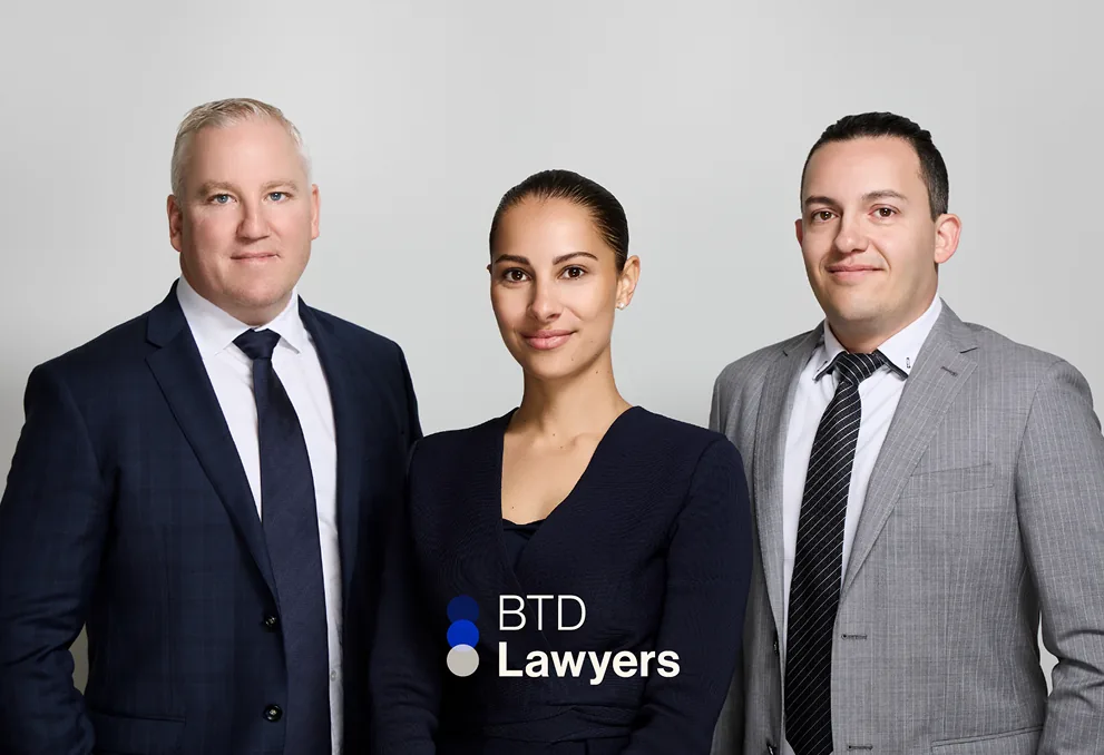 BTD Lawyers brand photography: three people in suits beside the BTD Lawyers logo