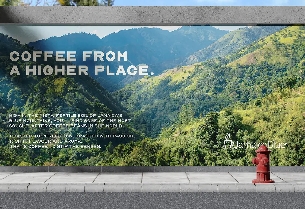 Jamaica Blue billboard: a green mountain valley under the headline “Coffee from a higher place”