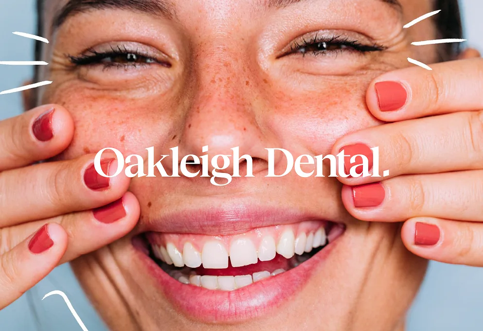 Oakleigh Dental brand identity: the wordmark over a close-up of a laughing woman framing her smile with her hands