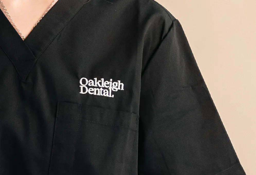 Oakleigh Dental uniform: the white wordmark on black scrubs
