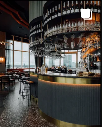 Post: a bar with a curved counter under shelves of glassware