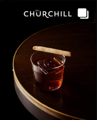 Post: a Churchill cocktail on a dark timber bar