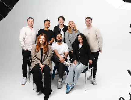 The Media Exchange team together in a white photo studio