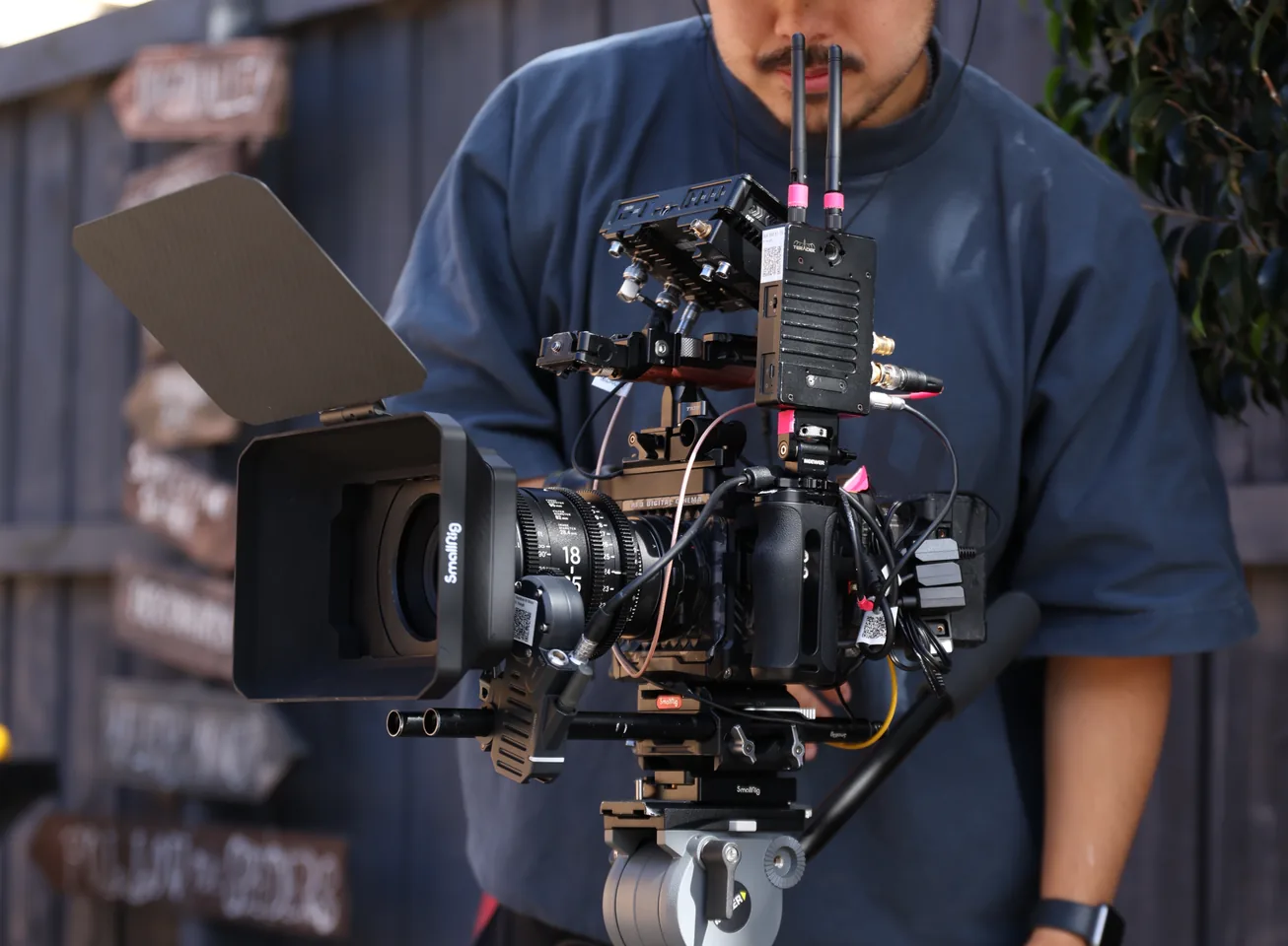 Camera operator filming with a cinema camera rig